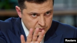 Ukraine's President Volodymyr Zelenskiy gestures as he speaks during a press marathon in Kyiv, Ukraine, Nov. 26, 2021. 