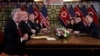 John Bolton, left, and others attend an extended bilateral meeting between North Korea's leader Kim Jong Un and U.S. President Donald Trump, in Hanoi, Vietnam Feb. 28, 2019. 