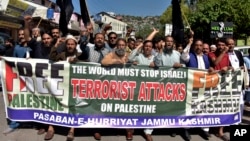 Protesters in Muzaffarabad, Pakistan, chant slogans against Israeli airstrikes on Gaza at a rally to show solidarity with Palestinian people on Oct. 10, 2023.