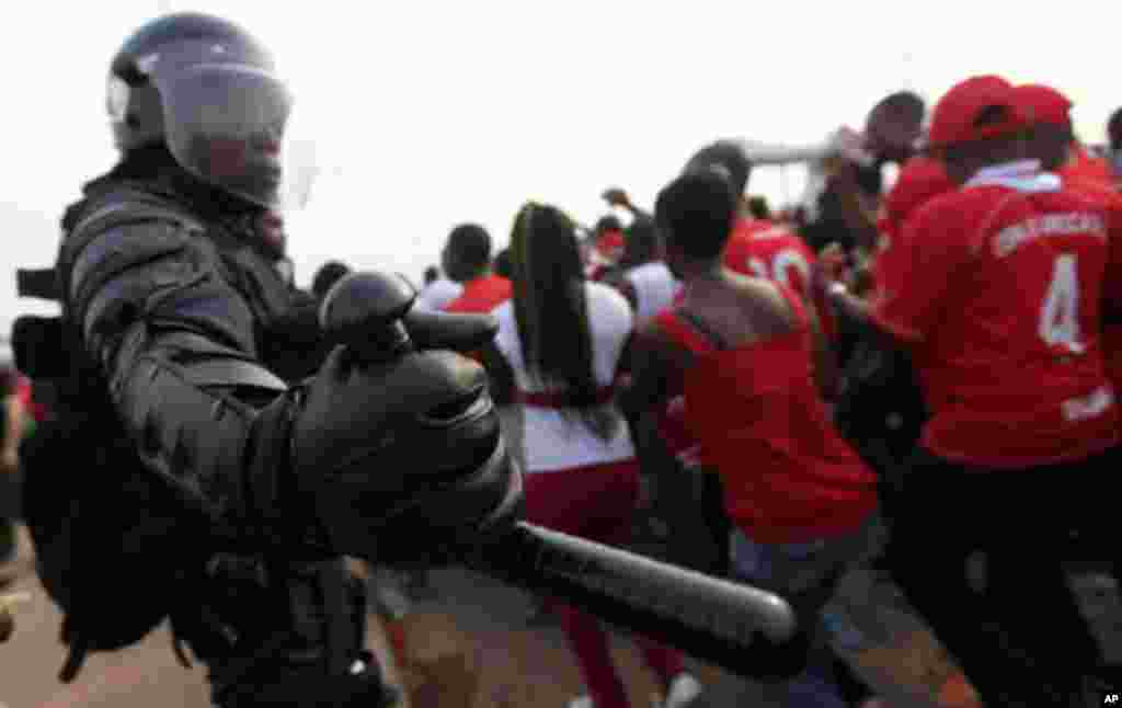 Equatorial Guinea's special police forces try to control Equatorial Guinea fans inside Estadio de Bata "Bata Stadium", which will host the opening match and ceremony for the African Nations Cup, in Bata January 21, 2012.