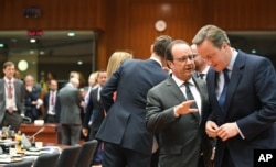 British Prime Minister David Cameron, right, speaks with French President Francois Hollande during a round table meeting at an EU summit in Brussels on Tuesday, June 28, 2016.