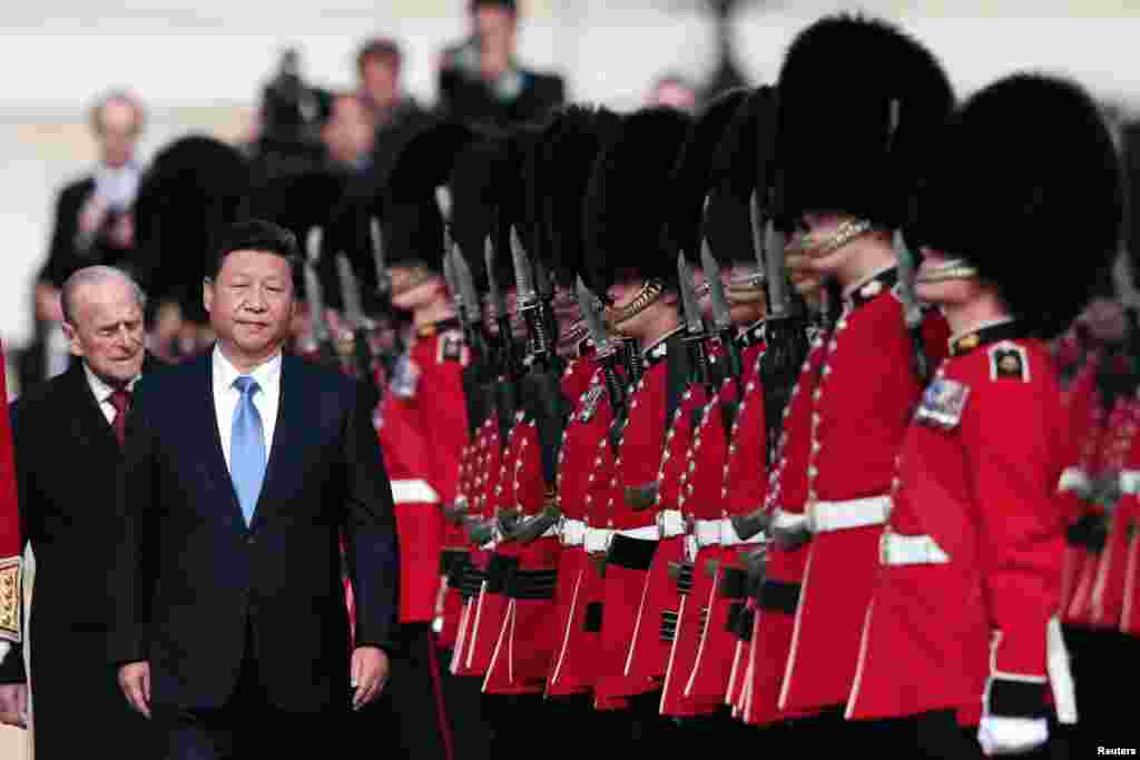 President Xi Jinping and Prince Philip review an honor guard during his official welcoming ceremony in London, Oct. 20, 2015.