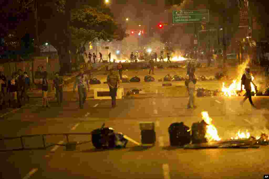 Objects placed by opposition protesters block a road in the Altamira neighborhood of Caracas, Feb. 20, 2014. 