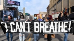 FILE - Protesters march through downtown Minneapolis a day before jury selection is scheduled to begin for the trial of Derek Chauvin, the former Minneapolis policeman accused of killing George Floyd, in Minneapolis, Minnesota, March 7, 2021.