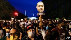 Demonstrators protest Saturday, June 6, 2020, near the White House in Washington, over the death of George Floyd, a black man who was in police custody in Minneapolis. Floyd died after being restrained by Minneapolis police officers. (AP Photo…