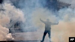 FILE - A Kashmiri Muslim protester shouts slogans amid tear gas during a protest in Srinagar, Indian-controlled Kashmir, Oct. 30, 2015. Kashmiris were protesting the killing of Abu Qasim, a Pakistani national and operations chief of the Lashkar-e-Taiba militant group.