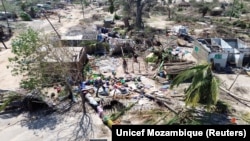 A person stands amid uprooted trees and debris after Cyclone Chido hit the Mecufi district, Cabo Delgado province, Mozambique, Dec. 16, 2024, in this screengrab taken from a handout drone video. 