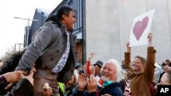 FILE - Mosque shooting survivor Abdul Aziz is held aloft as he thanks supporters outside the Christchurch High Court after the sentencing hearing for Australian Brenton Harrison Tarrant, in Christchurch, New Zealand on Aug. 27, 2020. Aziz is one of two wo