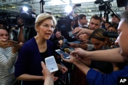 Democratic presidential candidate Sen. Elizabeth Warren, D-Mass., talks with reporters at Focus: HOPE in Detroit, June 4, 2019.