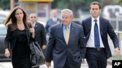 Sen. Bob Menendez, center, arrives with his children, Alicia Menendez and Robert Menendez Jr., at court in Newark, New Jersey, Sept. 6, 2017. 