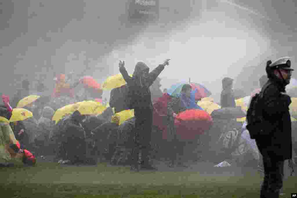 Dutch police uses a water cannon to break up a demonstration against coronavirus-related government policies including the curfew and the tight lockdown in Amsterdam, Netherlands.