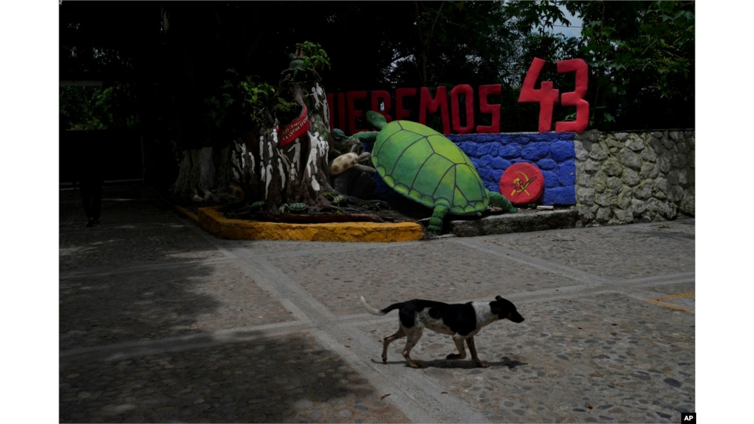 FILE - The entrance of the Raúl Isidro Burgos Rural Normal School features a turtle and the words 'We want the 43,' referring to the students who went missing 10 years ago, in Ayotzinapa, Guerrero state, Mexico, Aug. 19, 2024.