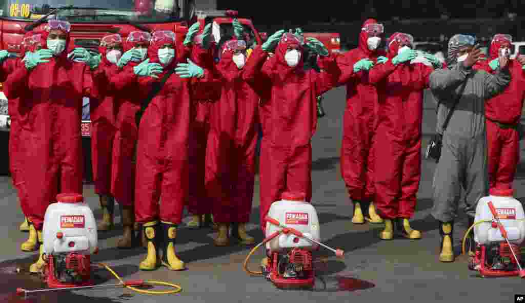 Indonesian firemen prepare to spray disinfectant to help curb the spread of the new coronavirus at Istiqlal Mosque in Jakarta.