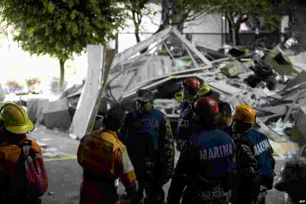 Regu penyelamat mencari korban di kantor pusat perusahaan minyak negara Meksiko (PEMEX) di Mexico City pasca ledakan yang mennguncang gedung tersebut, 31 Januari 2013. Dilaporkan sedikitnya 25 orang tewas dan 101 lainnya terluka dalam insiden tersebut. 