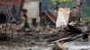 FILE - Children recycle goods from the ruins of a market which was set on fire at a Rohingya village outside Maugndaw in Rakhine state, Myanmar, Oct. 27, 2016. 