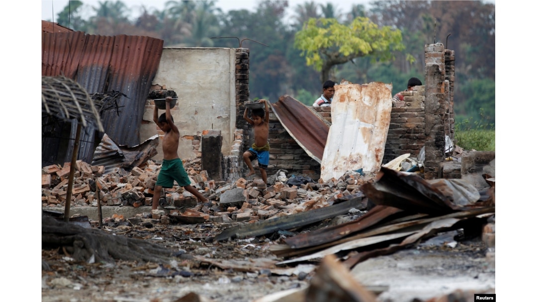 Children recycle goods from the ruins of a market which was set on fire at a Rohingya village outside Maugndaw in Rakhine state, Myanmar, Oct. 27, 2016.