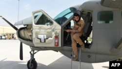 FILE - In a picture taken on Apr. 26, 2015, Afghanistan's first female pilot Niloofar Rahmani exits a fixed-wing Afghan Air Force aviator aircraft in Kabul. 