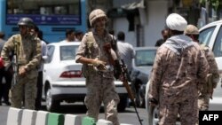 FILE - Members of the Iranian Revolutionary Guard are seen in Tehran, June 7, 2017.