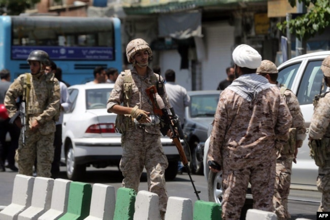 FILE - Members of the Iranian Revolutionary Guard are seen in Tehran, June 7, 2017.