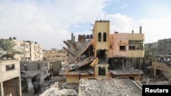 A view of a damaged house, as Palestinians inspect the damage at the site of Israeli strikes on houses, in Khan Younis in the southern Gaza Strip, December 13, 2023.