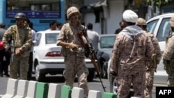 FILE - Members of the Iranian Revolutionary Guard are seen in Tehran, June 7, 2017.