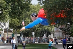 A giant inflatable Superman flies past the U.S. embassy on Balloon Day Parade in Brussels, Sept. 2013.