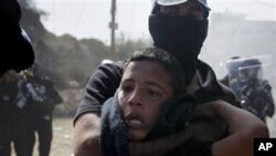 An Israeli Arab boy is detained by Israeli riot police during clashes in the northern Israeli town of Umm el-Fahm, Wednesday, Oct. 27, 2010