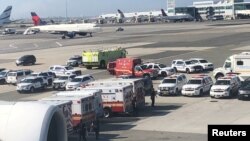 Emergency services are seen after passengers were taken ill on a flight from New York to Dubai, on JFK Airport, New York, Sept. 05, 2018 in this still image obtained from social media. (Larry Coben/via Reuters)