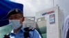 A police officer stands guard outside the Apple Daily headquarters on Thursday, June 17, 2021. AP/Kin Cheung