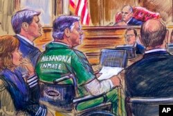 FILE - This courtroom sketch depicts former Trump campaign chairman Paul Manafort, center in a wheelchair, during his sentencing hearing in federal court before Judge T.S. Ellis III in Alexandria, Va., March 7, 2019.