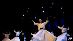 FILE - Whirling dervishes of the Mevlevi order perform during a Sheb-i Arus ceremony in Istanbul, Turkey, December 17, 2023. Every December a series of events are held to commemorate the death of the 13th century Islamic scholar, poet and Sufi mystic Jalaladdin Rumi. 
