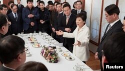 South Korean President Park Geun-hye speaks during a meeting with reporters at the Presidential Blue House in Seoul, South Korea, in this handout picture provided by the Presidential Blue House and released by Yonhap, Jan. 1, 2017. 