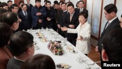 South Korean President Park Geun-hye speaks during a meeting with reporters at the Presidential Blue House in Seoul, South Korea, in this handout picture provided by the Presidential Blue House and released by Yonhap, Jan. 1, 2017.