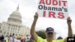 Demonstrators protest the Internal Revenue Service targeting of the Tea Party and similar groups during a rally outside the US Capitol in Washington, DC, June 19, 2013.