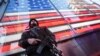 FILE - A heavily armed New York city police officer with the Strategic Response Group stands guard at New York's Times Square, Nov. 14, 2015.