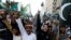 FILE - Supporters of Pervez Musharraf chant slogans after a Pakistani court sentenced the former military ruler to death on charges of high treason and subverting the constitution, during a protest in Karachi, Pakistan, Dec. 18, 2019.