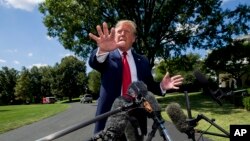 President Donald Trump speaks with reporters before departing on Marine One on the South Lawn of the White House, Aug. 21, 2019, in Washington.