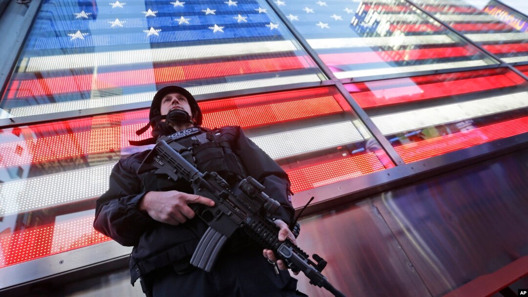 FILE - A heavily armed New York city police officer with the Strategic Response Group stands guard in New York's Times Square, Nov. 14, 2015. 