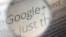 A computer monitor in Berlin displays information about Google+ service, seen through a magnifying glass, June 29, 2011