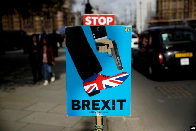 Brexit placards placed by anti-Brexit supporters stand opposite the Houses of Parliament in London, March 18, 2019.