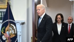 US President Joe Biden, Vice President Kamala Harris, and Attorney General Merrick Garland arrive in the Roosevelt Room of the White House in Washington, DC, on July 14, 2024.