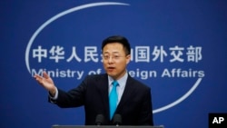 FILE - Chinese Foreign Ministry new spokesman Zhao Lijian speaks during a daily briefing at the Ministry of Foreign Affairs office in Beijing, Feb. 24, 2020. 