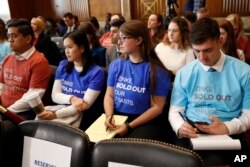Attendees of a Senate Committee on Energy and Natural Resources committee hearing wear t-shirts protesting Interior Secretary Ryan Zinke, as he testifies before the committee about the President's Budget Request for Fiscal Year 2019, March 13, 2018, on Ca