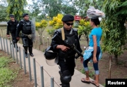 FILE - Riot police patrol in front of the court building during a protest to demand the release of demonstrators detained during protests against Nicaraguan President Daniel Ortega's government, in Managua, Nicaragua Oct. 10, 2018.