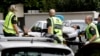 Para petugas ambulans membawa keluar seorang pria dari sebuah masjid di pusat Kota Christchurch, Selandia Baru, 15 Maret 2019. 