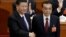 Chinese Premier Li Keqiang, right, shakes hands with Chinese President Xi Jinping, after he is re-elected premier for another term, at the sixth plenary session of the National People's Congress at the Great Hall of the People in Beijing, March 18, 2018. 