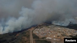 A Canadian Joint Operations Command aerial photo shows wildfires near neighborhoods in Fort McMurray, Alberta. (CF Operations)