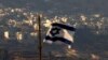 FILE - An Israeli flag flies near the Golan Heights village of Majdal Shams, Oct. 11, 2018.