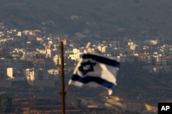 FILE - An Israeli flag flies near the village of Majdal Shams in the Golan Heights, Oct. 11, 2018.