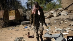 A Malian soldier walks inside a military camp used by radical Islamists and bombarded by French warplanes, in Diabaly, Mali, January 21, 2013.